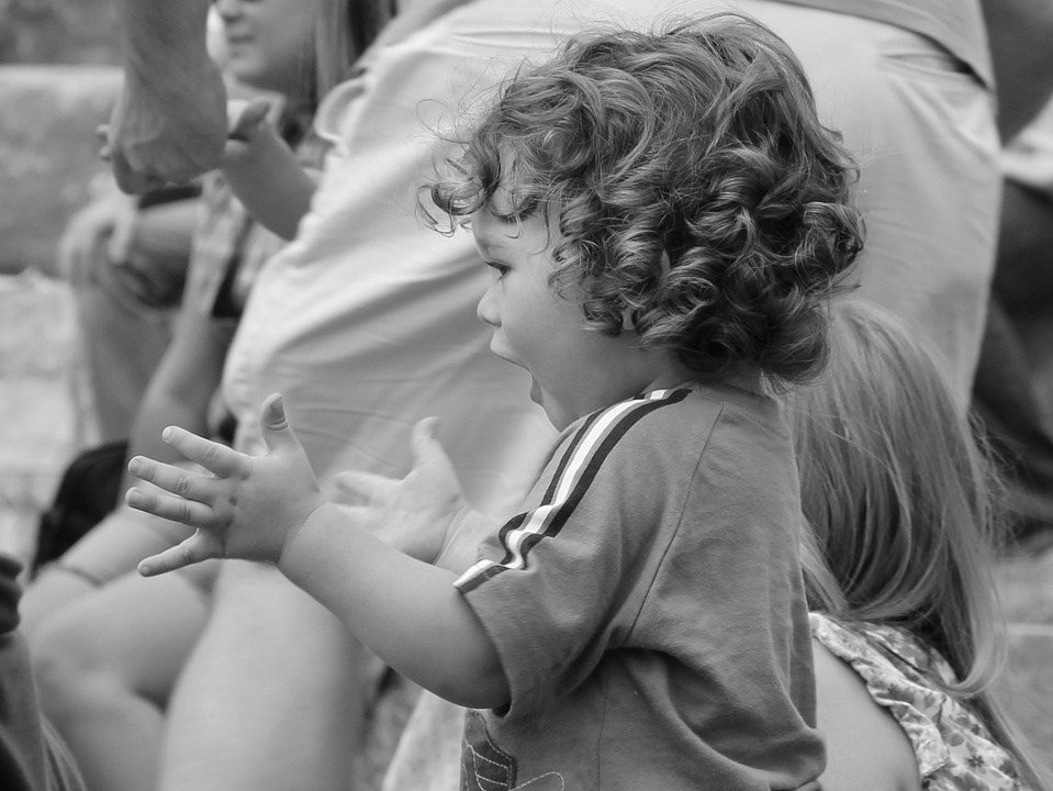 Black and white photo of toddler clapping